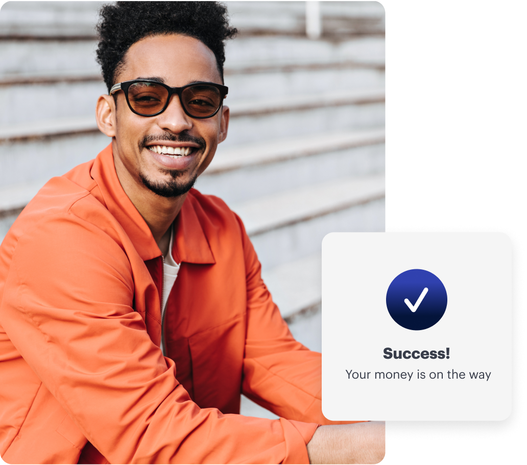 A smiling man in an orange jacket sits on steps. A notification on the image reads, "Success! Your money is on the way.